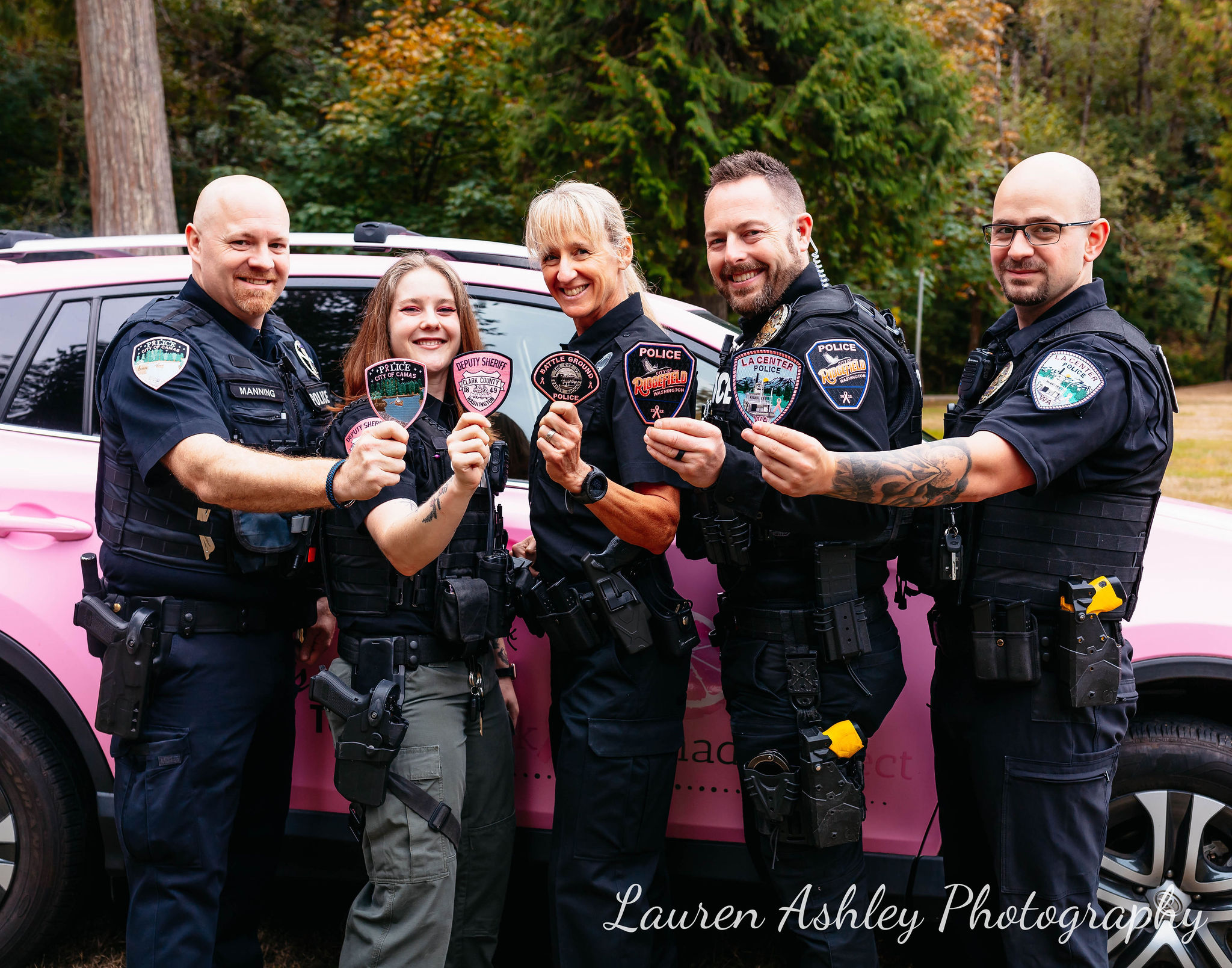 Police pose for photo with pink patches